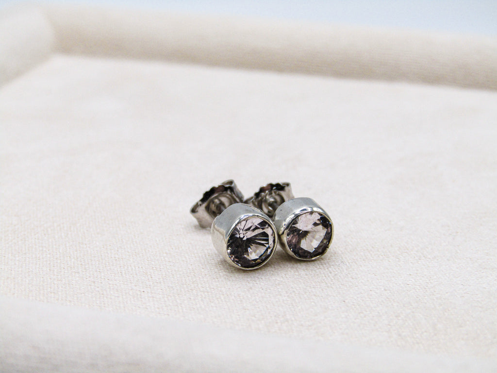 Silver stud earrings with clear gemstones on a white background