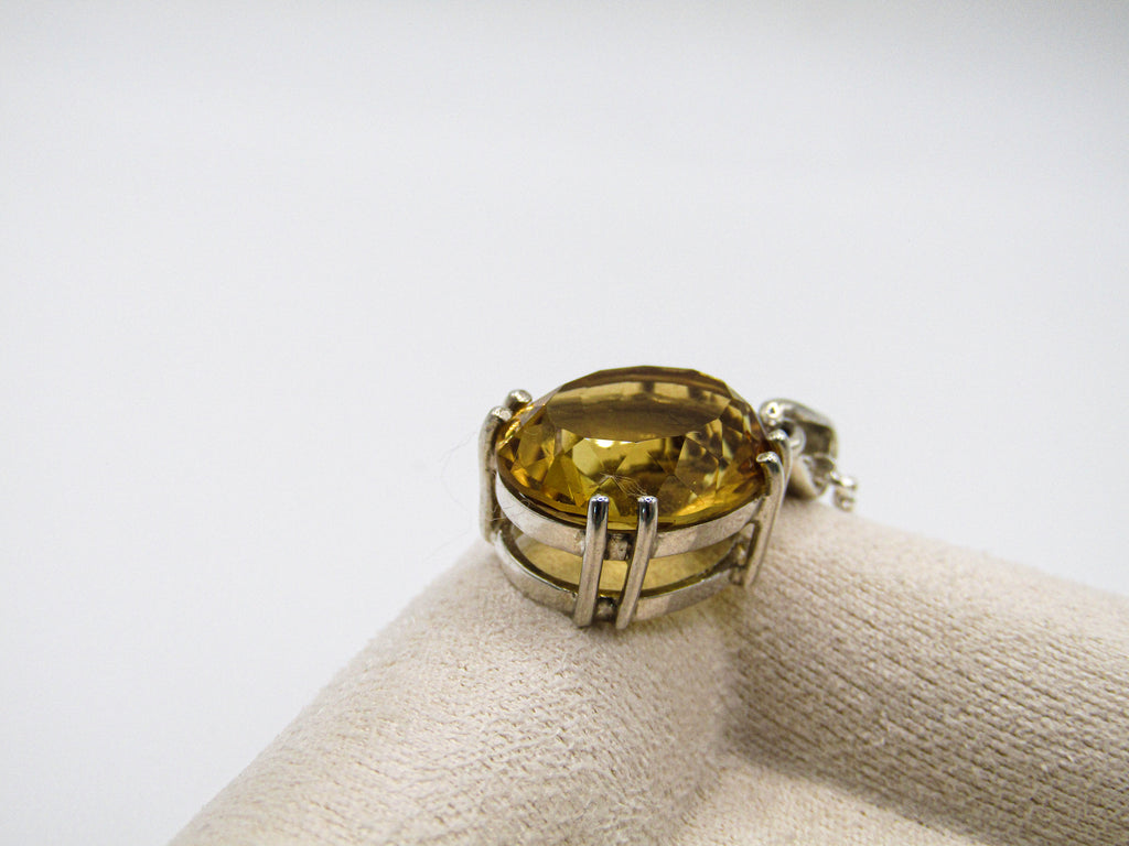 Ring with a yellow gemstone on a white background