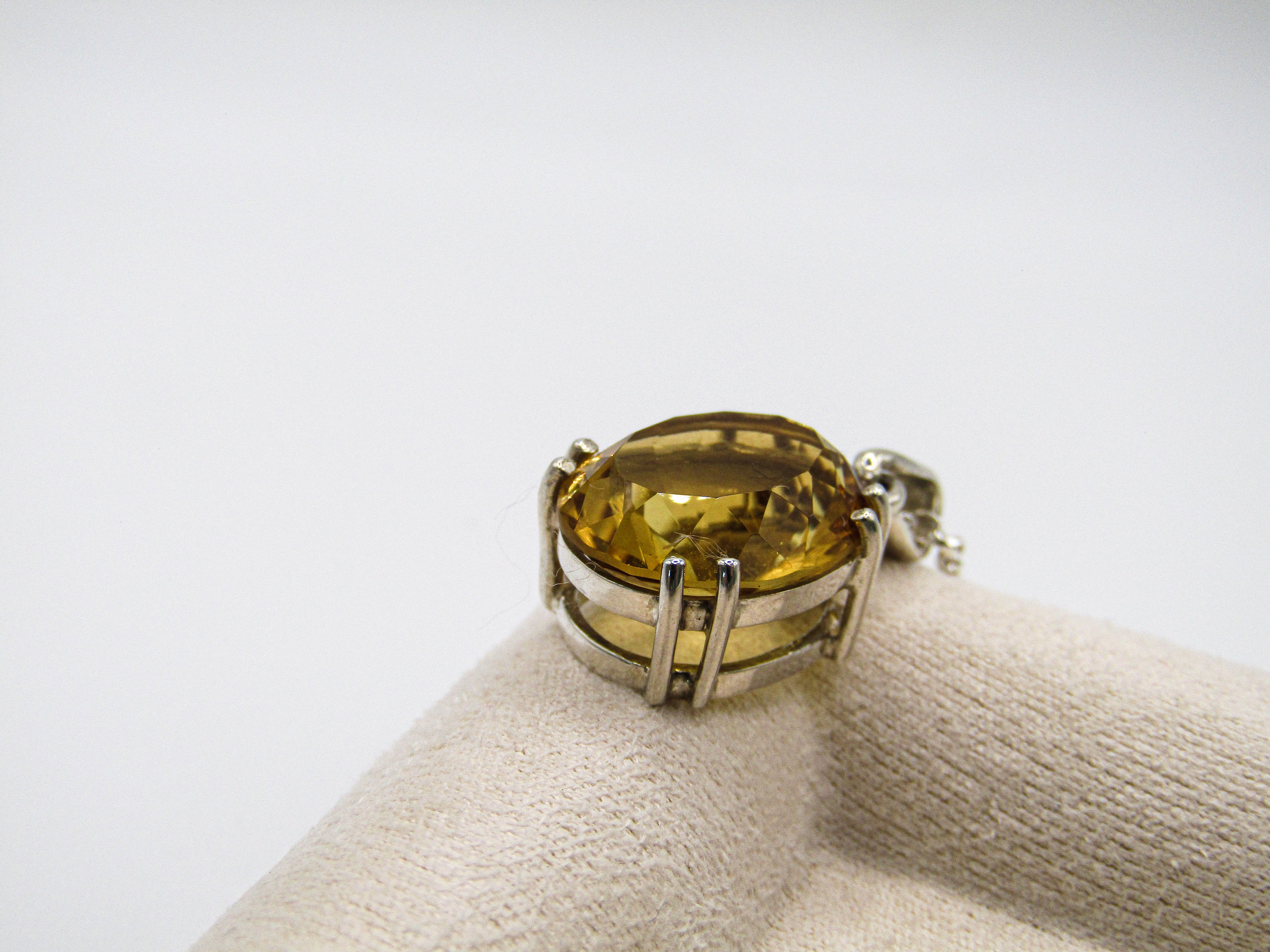 Ring with a yellow gemstone on a white background