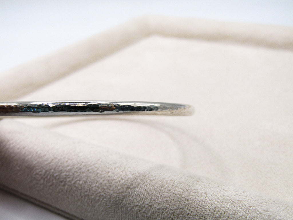 Silver hairpin on a textured white surface