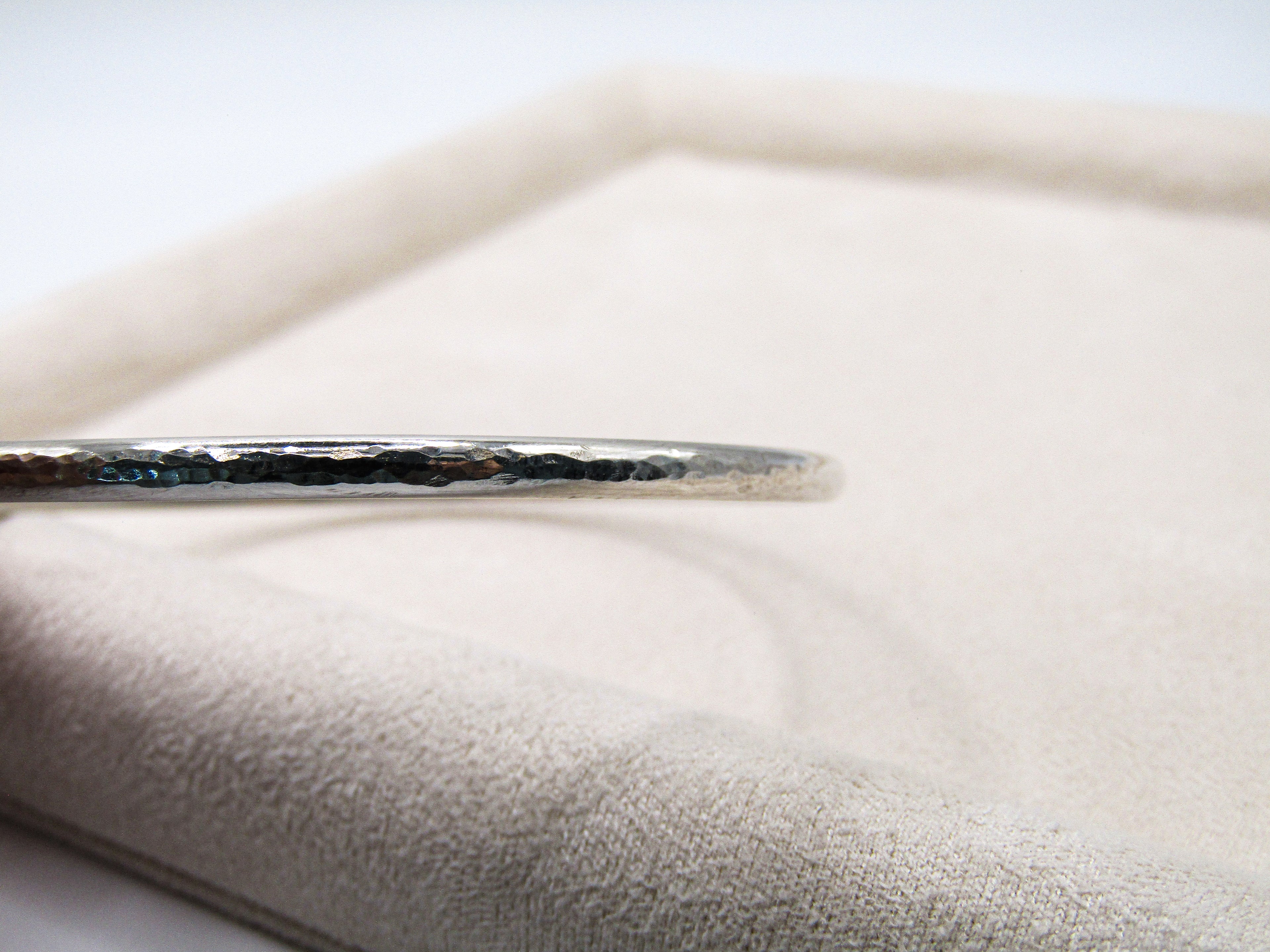 Silver hairpin on a textured white surface